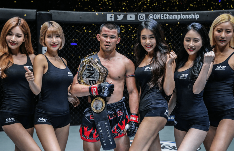Nong-O And Petchdam Walk Away From The Impact Arena With The Belts