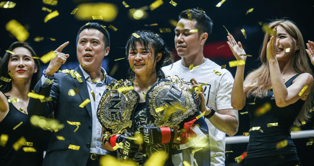 Stamp Fairtex celebrates with her two belts in the ONE cage